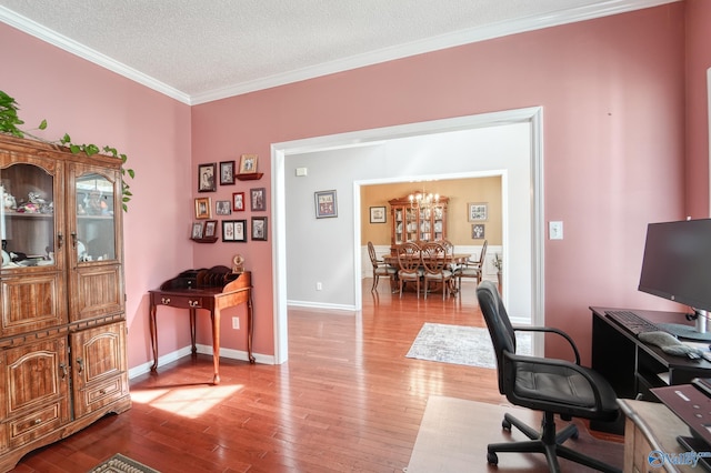 office with baseboards, a textured ceiling, light wood-style flooring, and crown molding