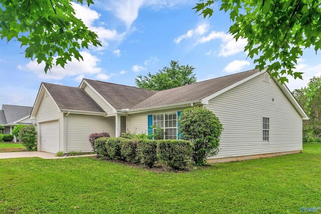 123 Otter Trl, Huntsville, AL 35824 - view of side of property with an attached garage, a lawn, driveway, and a shingled roof