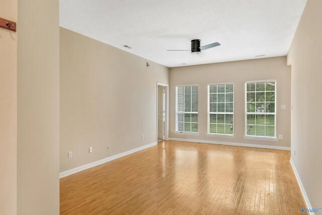 123 Otter Trl, Huntsville, AL 35824 - spare room featuring ceiling fan, light wood-style floors, and baseboards