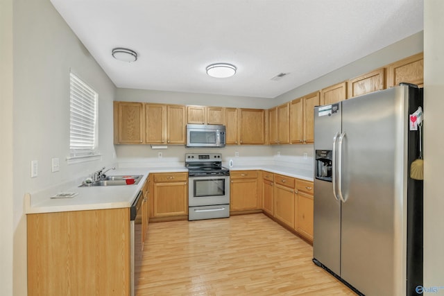 123 Otter Trl, Huntsville, AL 35824 - kitchen with stainless steel appliances, a sink, light wood-style flooring, and light countertops