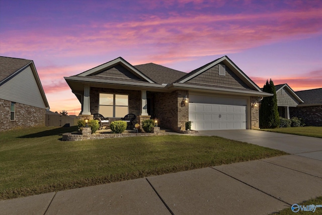 view of front facade with a yard and a garage