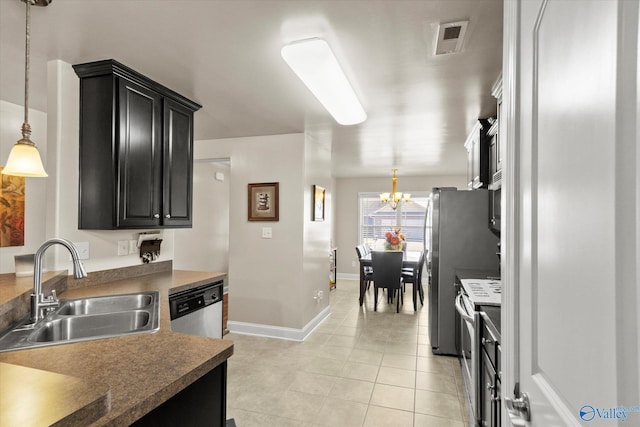 kitchen with sink, light tile patterned flooring, stainless steel appliances, decorative light fixtures, and an inviting chandelier