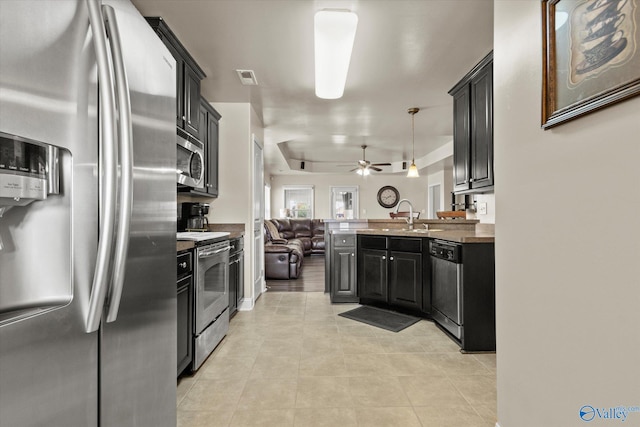 kitchen featuring sink, hanging light fixtures, ceiling fan, stainless steel appliances, and light tile patterned floors