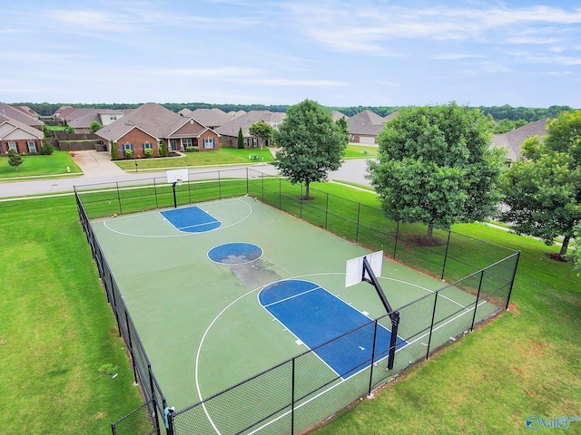 view of sport court featuring a lawn