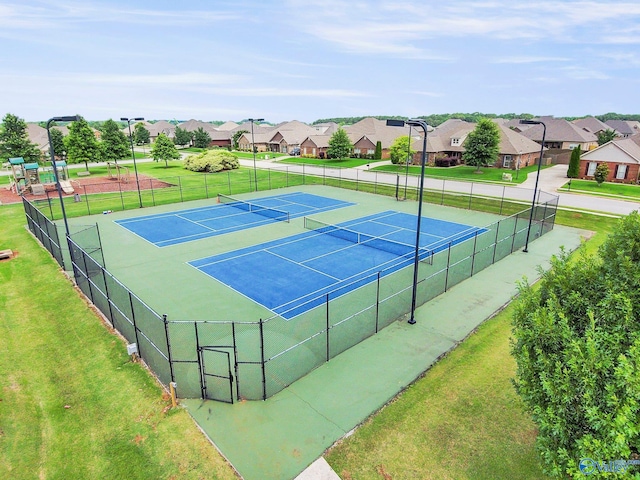 view of tennis court with a lawn