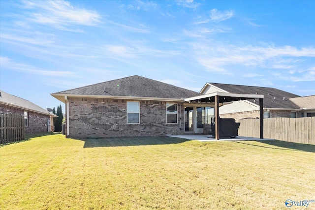 rear view of property featuring a patio area and a yard