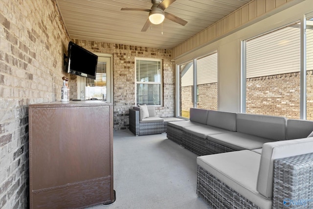 sunroom featuring ceiling fan and wooden ceiling