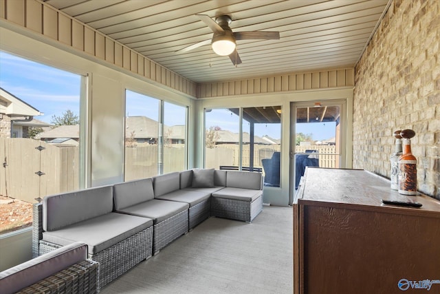 sunroom / solarium with ceiling fan and wooden ceiling