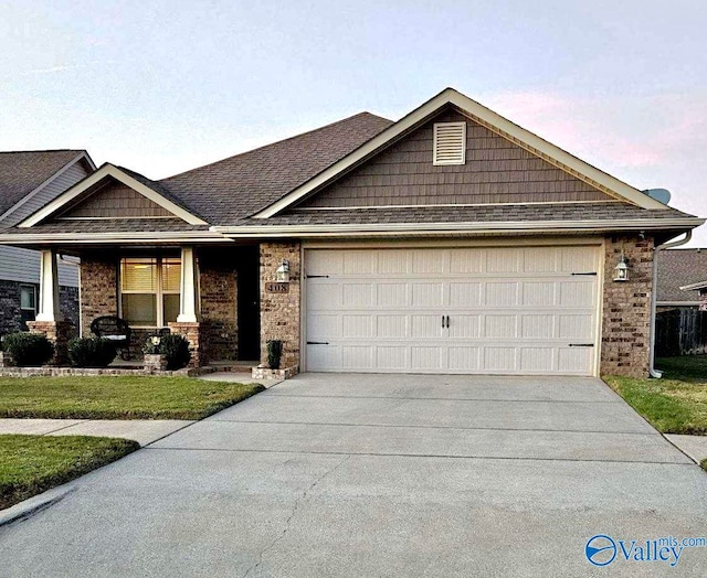 view of front of house with a lawn and a garage