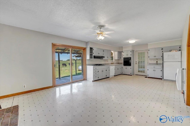 kitchen with exhaust hood, sink, a textured ceiling, white appliances, and ceiling fan