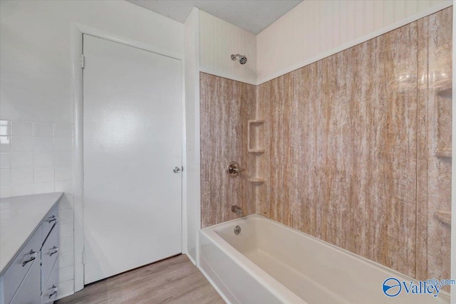 bathroom featuring vanity, hardwood / wood-style floors, and shower / bathtub combination