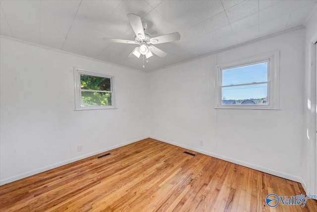 unfurnished room featuring ornamental molding, light hardwood / wood-style floors, and ceiling fan