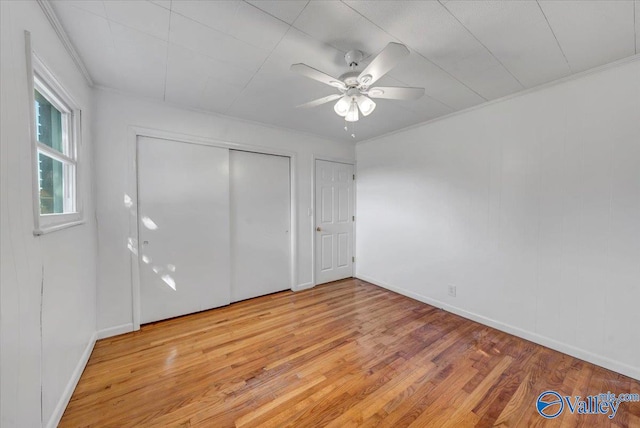 unfurnished bedroom with ornamental molding, light hardwood / wood-style flooring, and ceiling fan