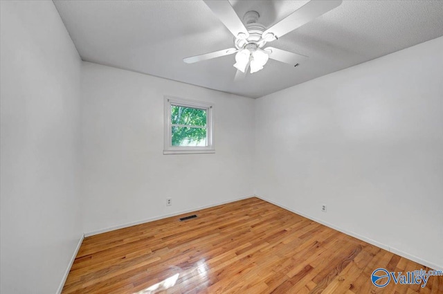 spare room with light hardwood / wood-style floors, a textured ceiling, and ceiling fan