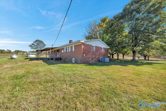 view of home's exterior with central AC and a lawn