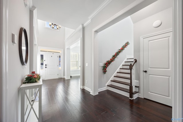 foyer featuring a notable chandelier, dark hardwood / wood-style floors, and ornamental molding