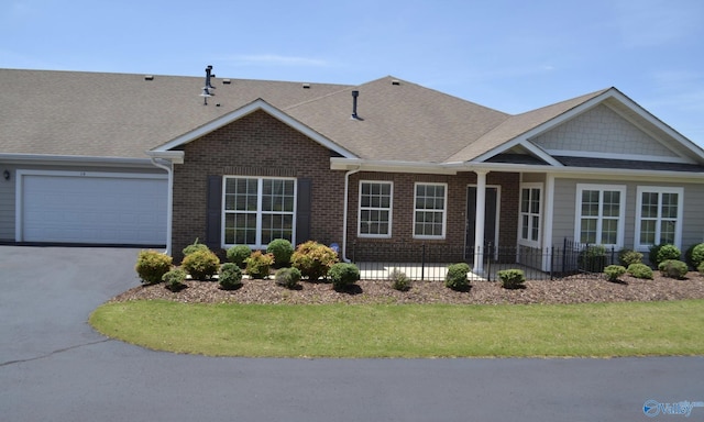 14 Moore Farm Cir NW Unit 14, Huntsville, AL 35806 - view of front of property with driveway, brick siding, an attached garage, a shingled roof, and a front lawn