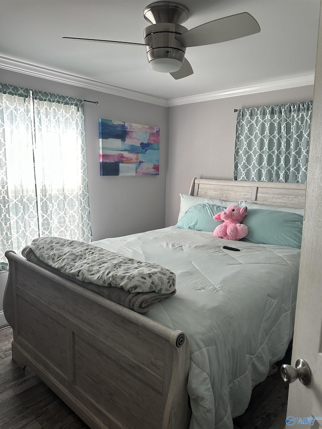 bedroom with crown molding, ceiling fan, and wood finished floors