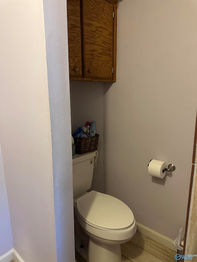 bathroom with toilet and tile patterned floors