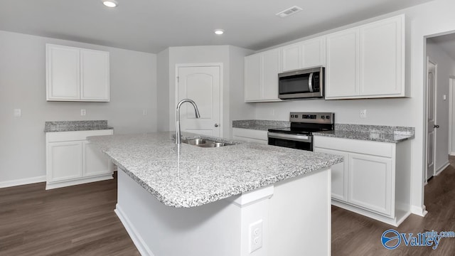 kitchen featuring sink, a kitchen island with sink, white cabinetry, stainless steel appliances, and light stone countertops