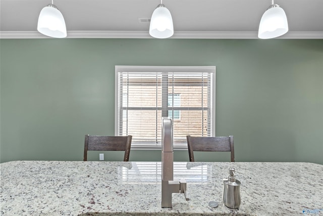 dining space with ornamental molding