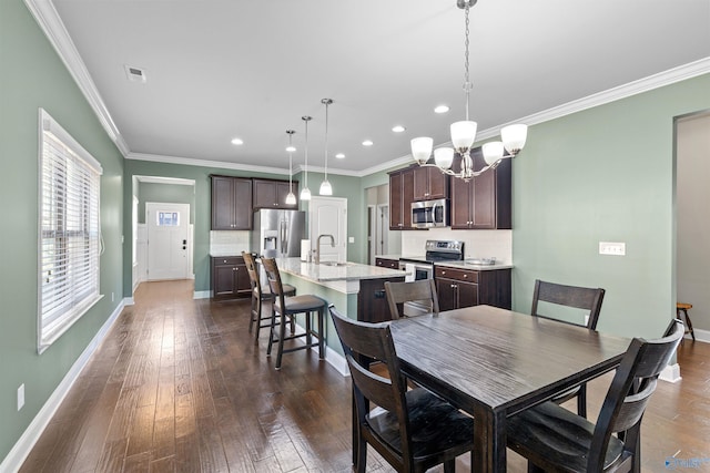 dining space with baseboards, dark wood finished floors, an inviting chandelier, recessed lighting, and ornamental molding