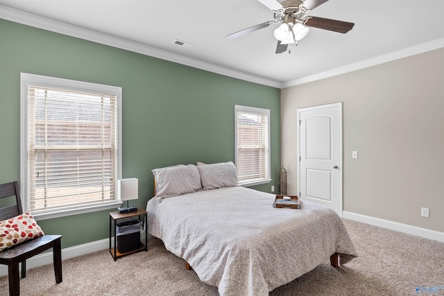 bedroom with visible vents, carpet floors, crown molding, baseboards, and ceiling fan