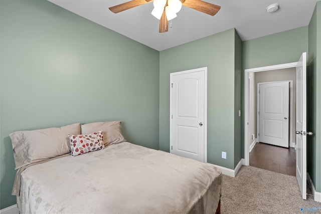 carpeted bedroom with a ceiling fan and baseboards