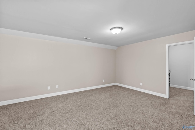 carpeted empty room with visible vents and baseboards