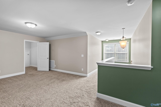 carpeted empty room featuring visible vents and baseboards