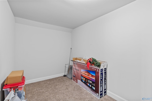 rec room with baseboards and carpet floors