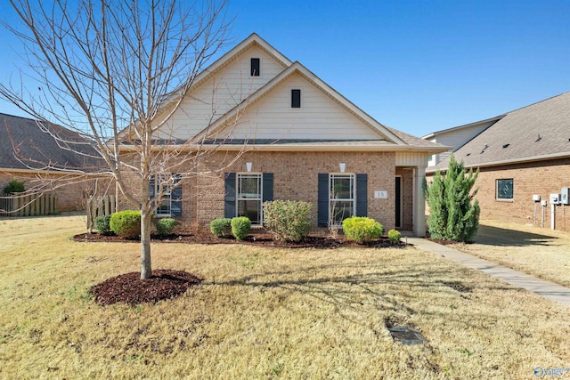 view of front of home with brick siding and a front yard