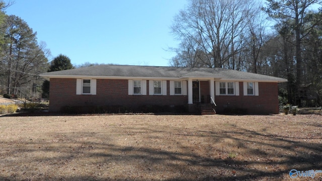 single story home with a front yard and brick siding