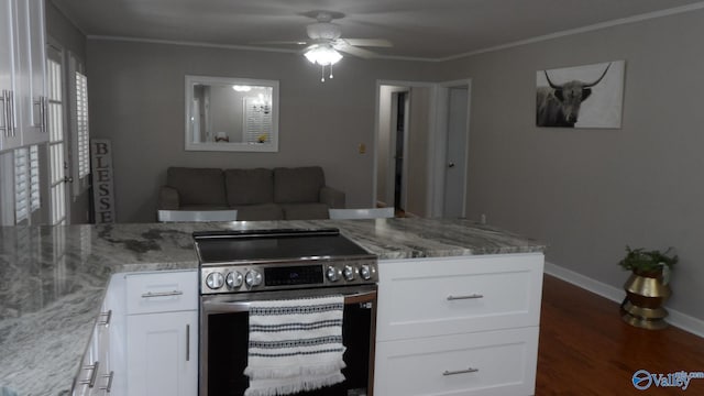 kitchen with light stone countertops, stainless steel electric stove, ornamental molding, and white cabinets