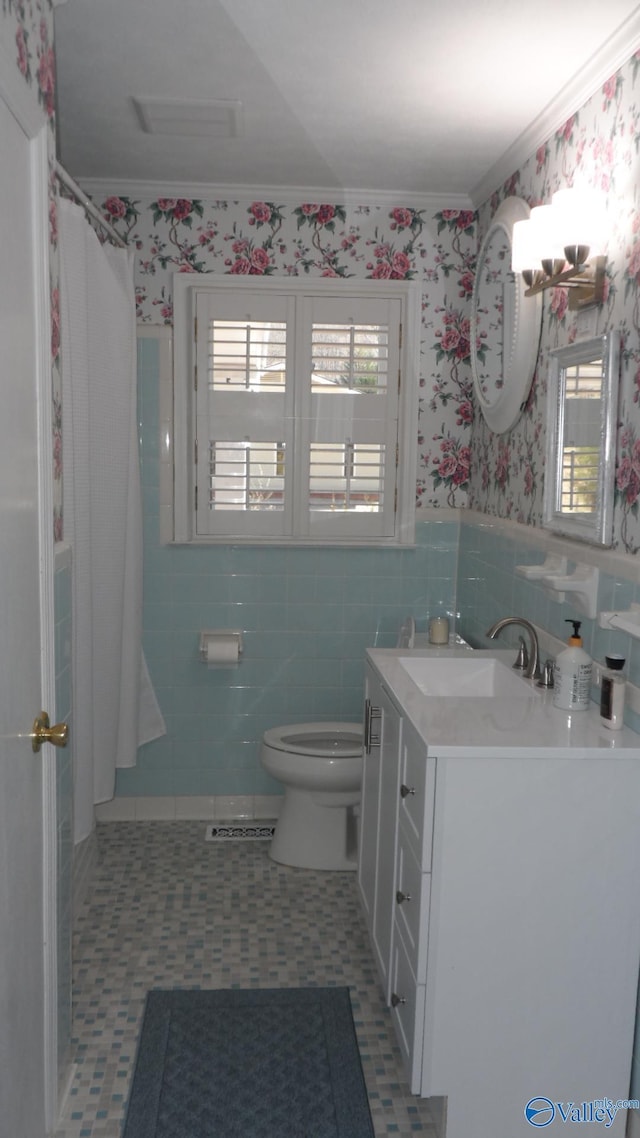 full bath with wallpapered walls, toilet, vanity, and ornamental molding