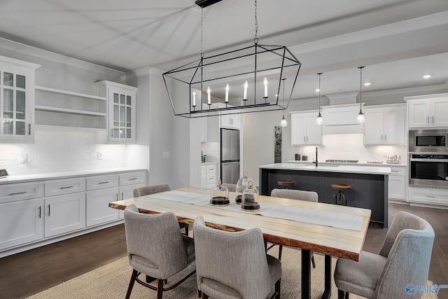 dining room featuring recessed lighting, ornamental molding, and dark wood finished floors