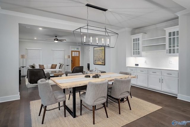 dining space with crown molding, dark wood-style flooring, a ceiling fan, and recessed lighting