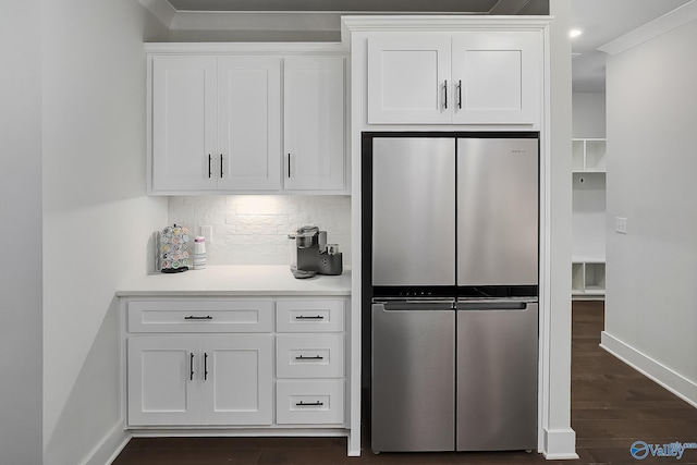 kitchen with light countertops, baseboards, freestanding refrigerator, dark wood-style floors, and white cabinetry