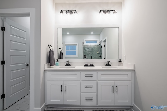 full bath featuring a sink, a stall shower, double vanity, and marble finish floor