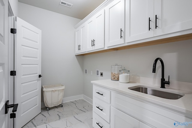 washroom featuring visible vents, hookup for a washing machine, a sink, cabinet space, and hookup for an electric dryer