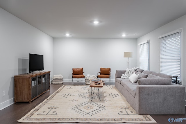 living area with baseboards, recessed lighting, and wood finished floors