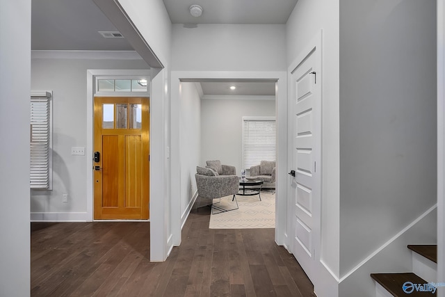 entryway with crown molding, baseboards, a healthy amount of sunlight, dark wood-type flooring, and visible vents
