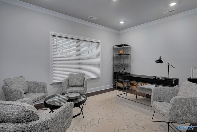interior space featuring visible vents, baseboards, crown molding, and light wood-type flooring