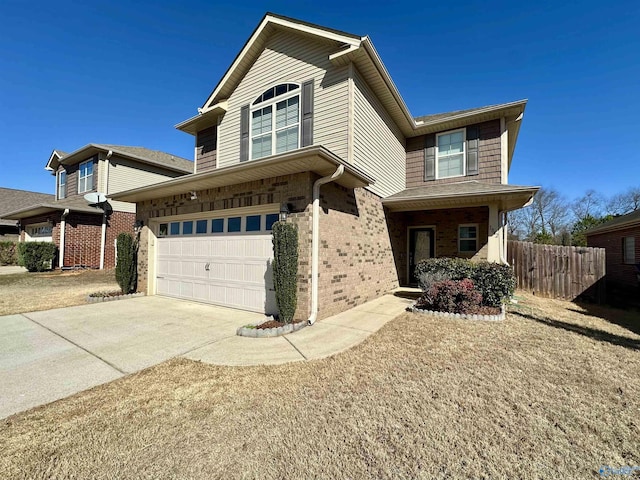 traditional home featuring concrete driveway, brick siding, an attached garage, and fence