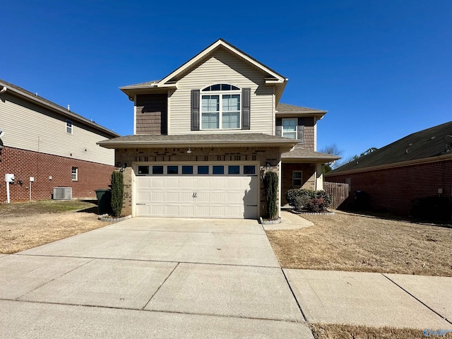 traditional home featuring a shingled roof, concrete driveway, an attached garage, cooling unit, and brick siding