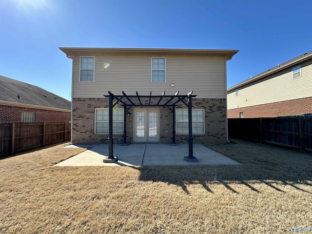 back of property featuring a fenced backyard, a patio, a pergola, and french doors