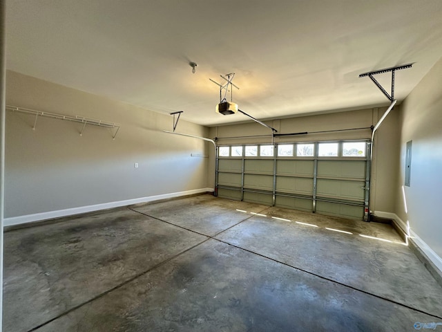 garage featuring baseboards, electric panel, and a garage door opener