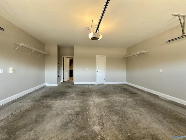 garage with a garage door opener and baseboards