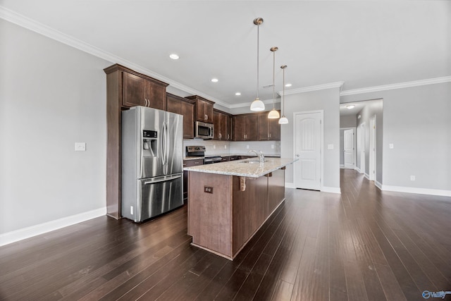 506 Foxridge Dr SW, Hartselle, AL 35640 - kitchen featuring dark brown cabinets, a sink, an island with sink, stainless steel appliances, and a kitchen bar