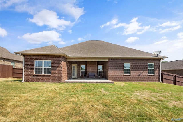 506 Foxridge Dr SW, Hartselle, AL 35640 - back of property featuring a fenced backyard, a patio, roof with shingles, and brick siding